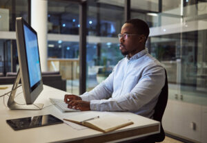 Image of marketer checking file downloads on computer